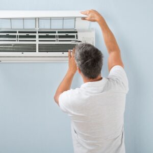 man adjusting ac