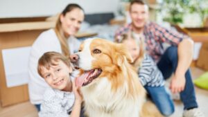 family with dog in living room