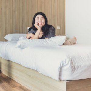 happy woman in her bedroom